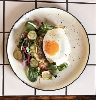 Beafsteak with mushed potatoes, fried egg, pickled cucumber, onions and mixed salad
