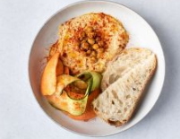 Hummus with smoked paprika, cucumber and carrot slices with sourdough bread tartin