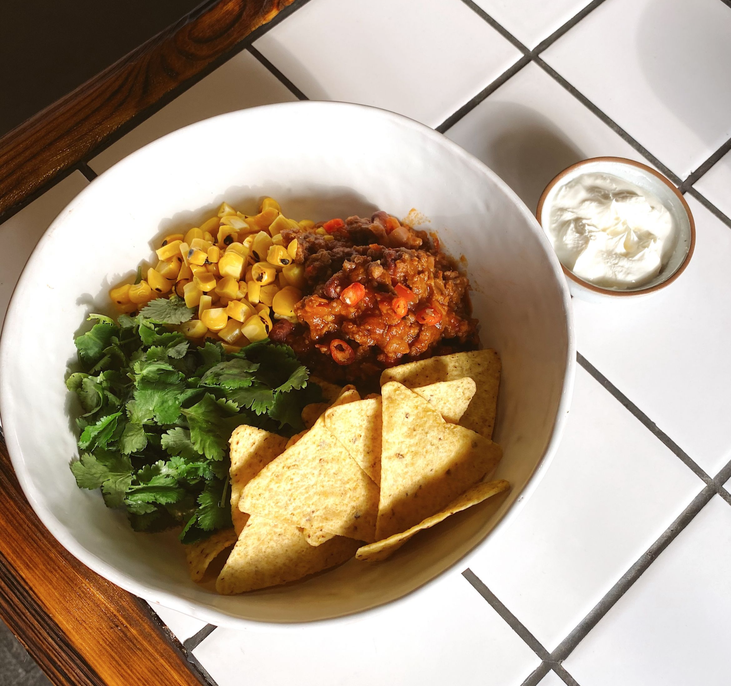 Chili con carne with beef and lamb, nachos, corn and sour cream