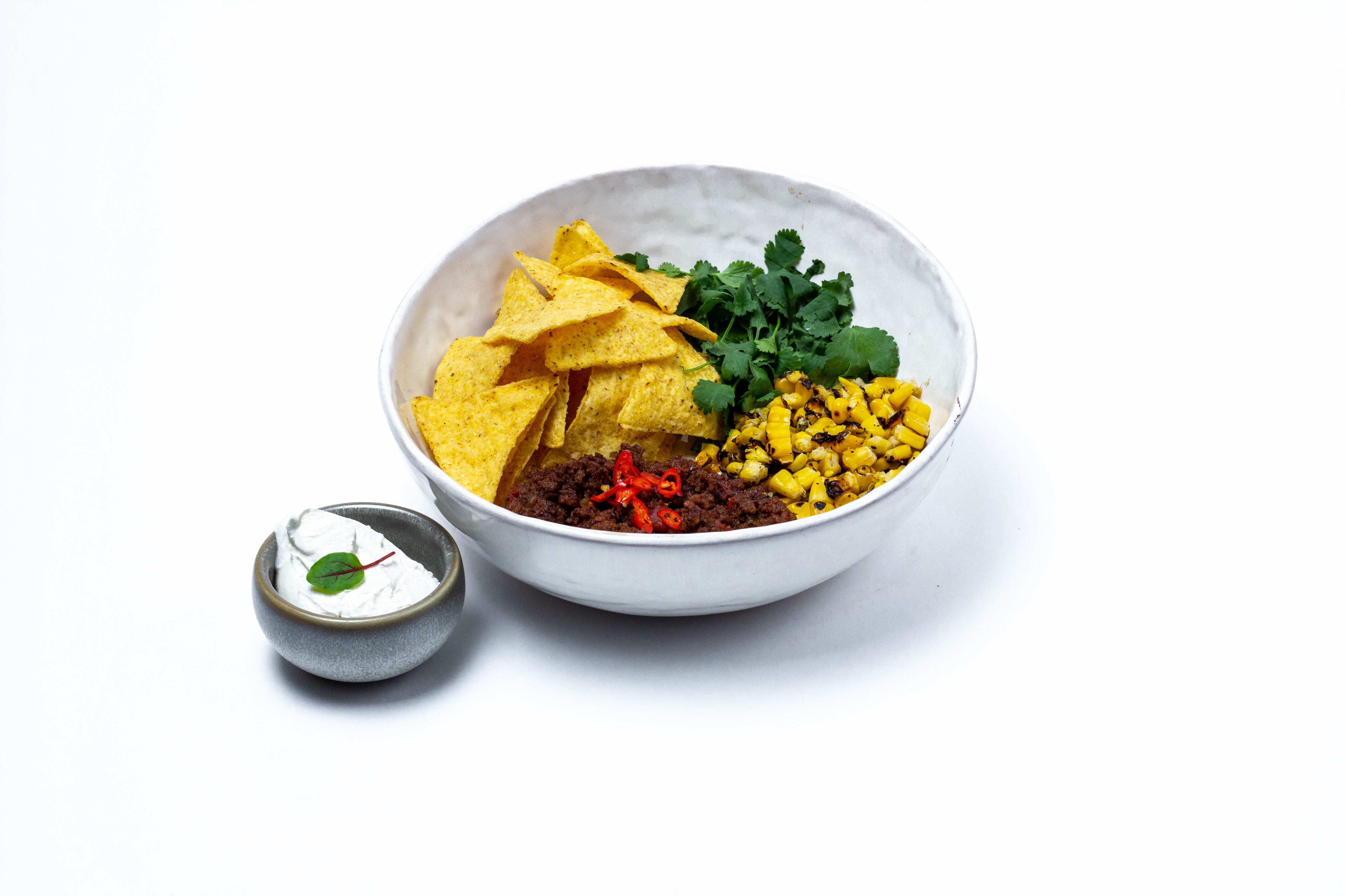 Chili con carne with beef and lamb, nachos, corn and sour cream