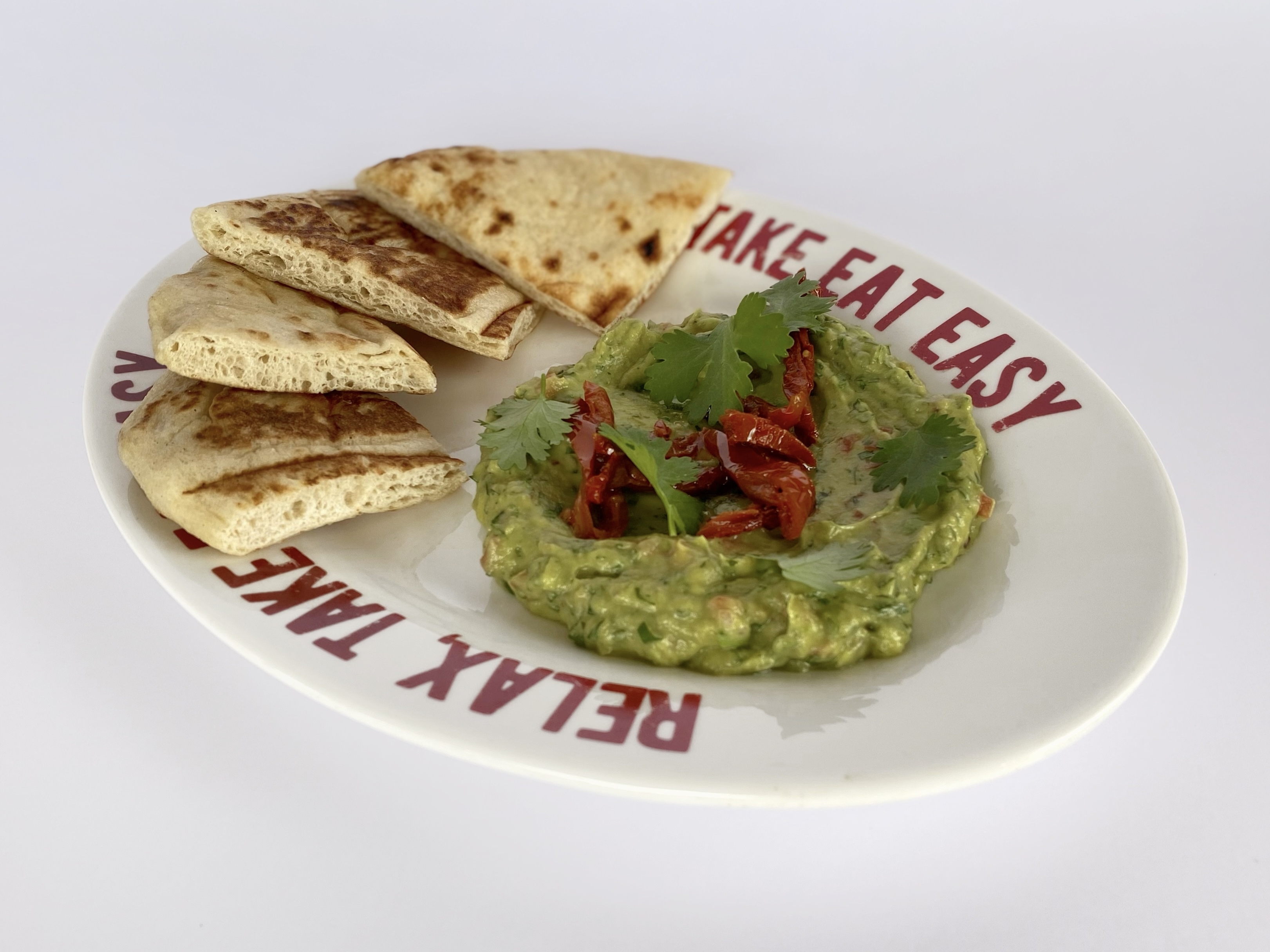 Guacamole with dried tomatoes and pita<br>